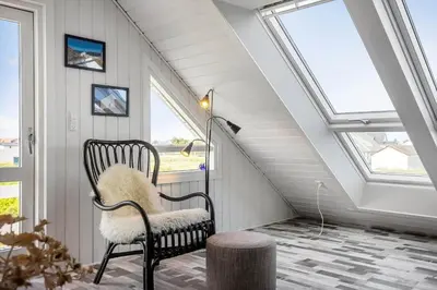 a room with a chair and a lamp and windows at 663-Thisted-Nordsovej-166 in Thisted