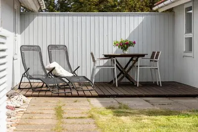 a patio with a table and chairs on a deck at 663-Thisted-Nordsovej-166 in Thisted