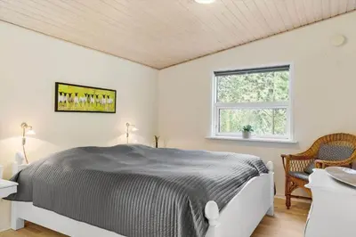 a white bedroom with a bed and a window at 589-Thisted-Klitrosevej-3 in Thisted