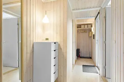 a hallway with a white refrigerator in a room at 435-Vestervig-Sivsangervej-32 in Vestervig