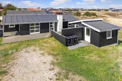 a house with a black roof and a yard at 486-Thisted-Fiskervej-57 in Thisted