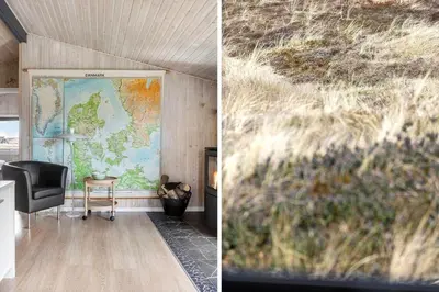 a room with a map and a chair and a tv at 486-Thisted-Fiskervej-57 in Thisted