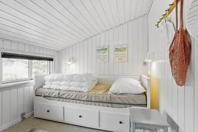 a bedroom with a bed in a white room at 788-Thisted-Blamunkevej-46 in Thisted