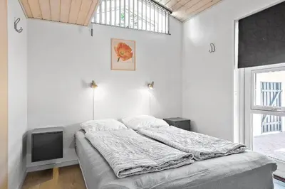 a white bedroom with a bed and a tv at 404-Thisted-Klemsvej-16 in Thisted