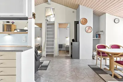 a kitchen and a living room with a table and chairs at 404-Thisted-Klemsvej-16 in Thisted