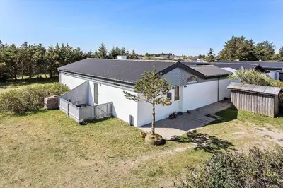 a white house with a tree in the yard at 404-Thisted-Klemsvej-16 in Thisted
