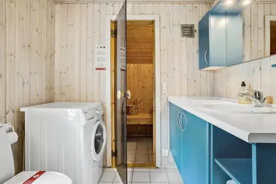 a bathroom with a washing machine and a sink at 248-Thisted-Molgaardsvej-28 in Thisted