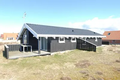 a black house with a porch and a deck at 123-Thisted-Orredvej-30 in Thisted
