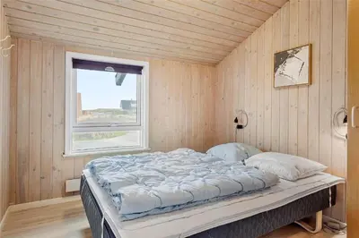 a bedroom with a bed in a room with a window at 123-Thisted-Orredvej-30 in Thisted