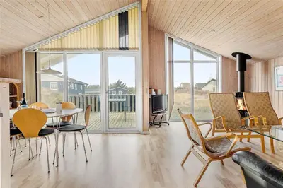 a living room with a table and chairs and a television at 123-Thisted-Orredvej-30 in Thisted