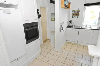 a kitchen with white cabinets and a stove at 1321-Thisted-Blamunkevej-58 in Thisted