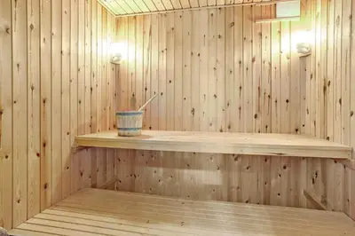 a sauna with a drink sitting on a wooden shelf at 849-Thisted-Havtornvej-6 in Thisted