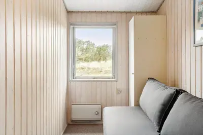 a small bedroom with a bed and a window at 849-Thisted-Havtornvej-6 in Thisted