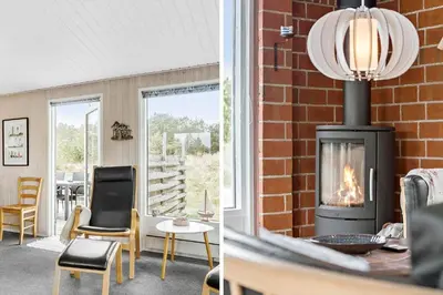 a living room with a brick wall and a fireplace at 849-Thisted-Havtornvej-6 in Thisted