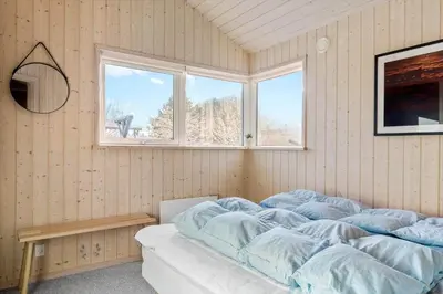 a bedroom with a bed with blue sheets and a window at 170-Thisted-Sotungevej-2 in Thisted