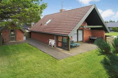 a house with a wooden deck in the yard at 400-Thisted-Nordsovej-186 in Thisted