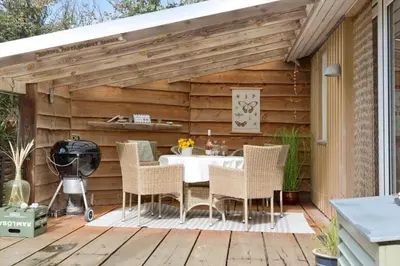 a patio with a table and chairs on a deck at 269-Vestervig-Blishonevej-19 in Vestervig