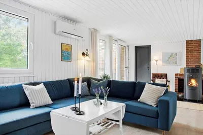 a living room with a blue couch and a table at 269-Vestervig-Blishonevej-19 in Vestervig