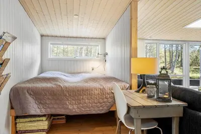 a bedroom with a bed and a table with chairs at 286-Thisted-Blamunkevej-49 in Thisted