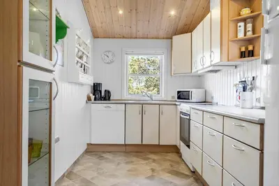 a kitchen with white cabinets and a window at 286-Thisted-Blamunkevej-49 in Thisted