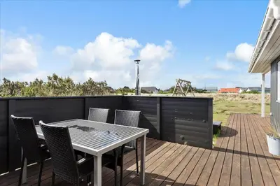 a patio with a table and chairs on a deck at 497-Thisted-Nordsovej-26 in Thisted