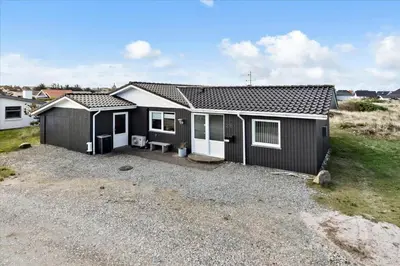 a black and white house with a gravel driveway at 497-Thisted-Nordsovej-26 in Thisted