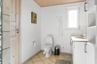 a white bathroom with a toilet and a sink at 497-Thisted-Nordsovej-26 in Thisted