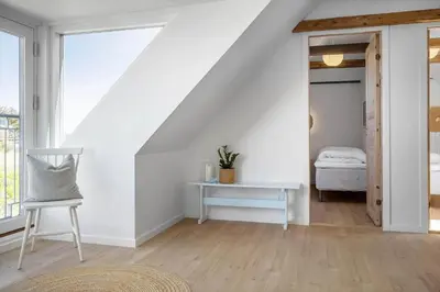 a white room with a white table and a chair at 1313-Thisted-Hotelvej-4 in Thisted