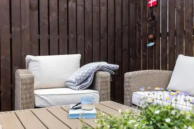 a patio with two wicker chairs and a table at 1313-Thisted-Hotelvej-4 in Thisted
