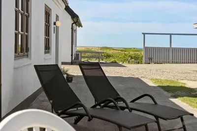 two chairs sitting on a patio near a building at 1313-Thisted-Hotelvej-4 in Thisted