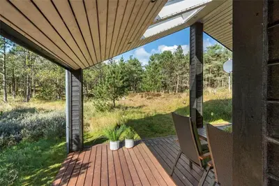 an outdoor deck with chairs and awning at 748-Thisted-Blamunkevej-65 in Thisted