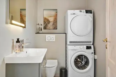 a small bathroom with a washing machine and a sink at 878-Thisted-Smedevej-15 in Thisted