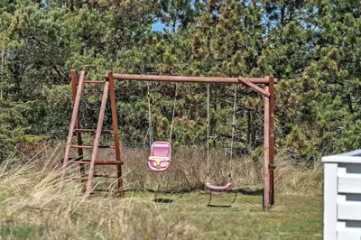 an old swing with a pink chair on it at 878-Thisted-Smedevej-15 in Thisted