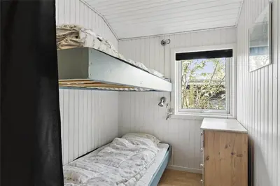 a small room with a bed and a window at 505-Thisted-Fiskervej-50-A in Thisted