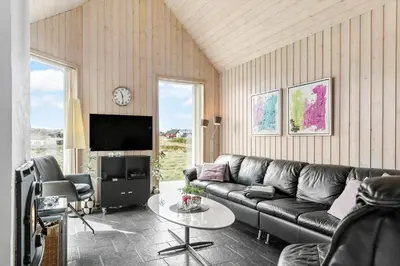 a living room with a couch and a table at 262-Vestervig-Magevej-15 in Vestervig