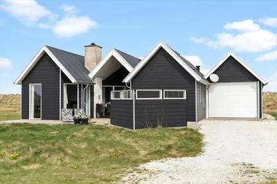 a black house with a white garage at 262-Vestervig-Magevej-15 in Vestervig