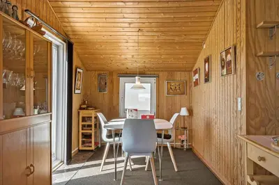 a kitchen with a table and chairs in a room at 306-Vestervig-Klitvej-6 in Vestervig