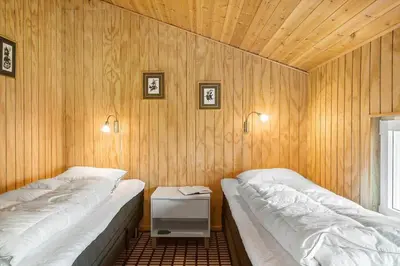 two beds in a room with wooden walls at 306-Vestervig-Klitvej-6 in Vestervig