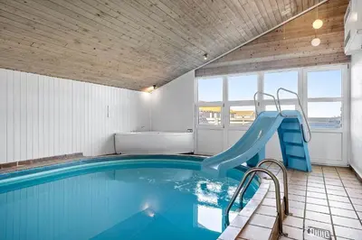 a indoor swimming pool with a slide in a house at 941-Thisted-Klitstien-37 in Torsted