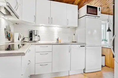 a white kitchen with white appliances and white cabinets at 851-Thisted-Blabaervej-1 in Thisted