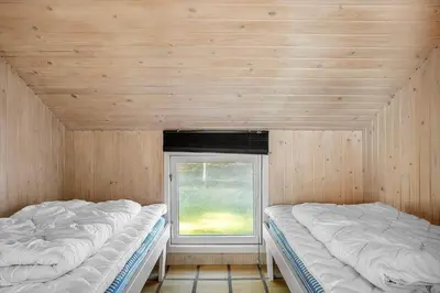 two beds in a room with a window at 1312-Thisted-Kristinesvej-38 in Thisted