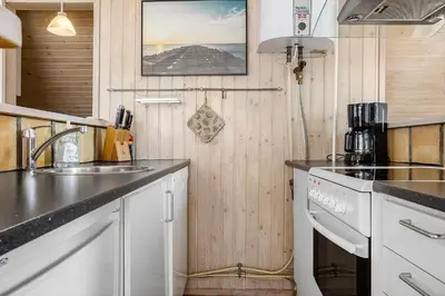 a kitchen with a sink and a stove top oven at 1312-Thisted-Kristinesvej-38 in Thisted