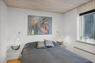 a bedroom with a bed and a painting on the wall at 699-Thisted-Sotungevej-33 in Thisted