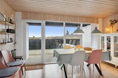 a kitchen and dining room with a table and chairs at 699-Thisted-Sotungevej-33 in Thisted