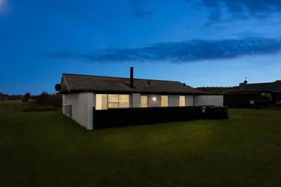 a house with a dark roof on a grass field at 699-Thisted-Sotungevej-33 in Thisted