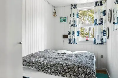 a bedroom with a bed and a window at 809-Thisted-Aerenprisvej-11 in Thisted