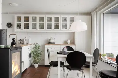 a kitchen with a table and chairs and a fireplace at 426-Thisted-Havbovej-26 in Thisted