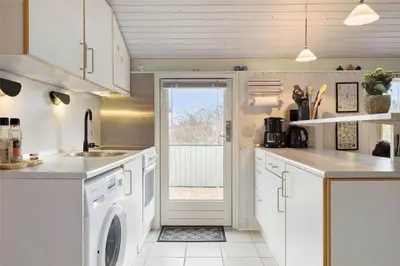 a kitchen with a washer and dryer in it at 802-Thisted-Pighvarvej-22 in Thisted