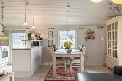 a kitchen with a table and chairs in a kitchen at 802-Thisted-Pighvarvej-22 in Thisted