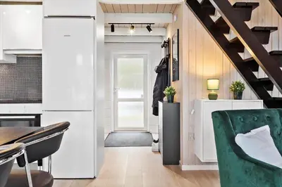 a kitchen with a door and a green chair at 169-Thisted-Fiskervej-69 in Thisted